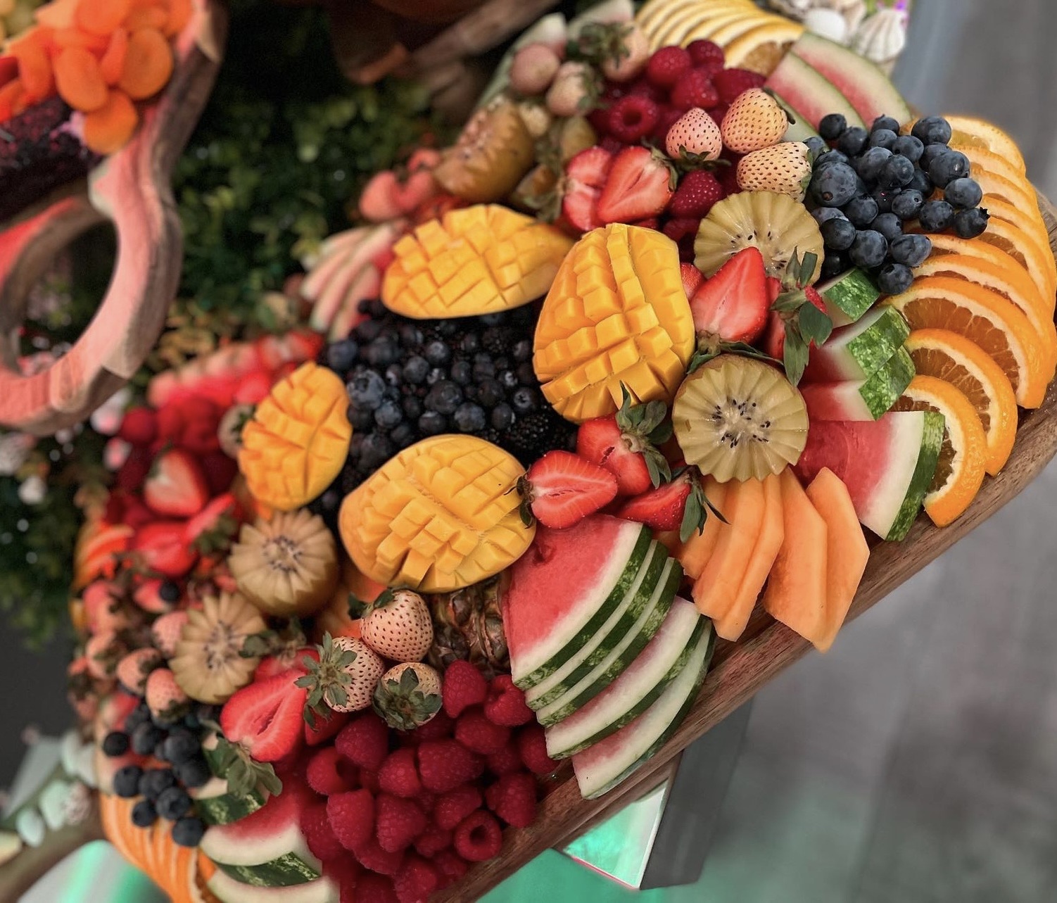 Fresh fruit platter with mango, strawberries and berries