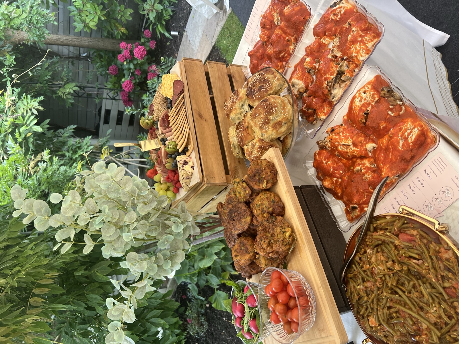 Savoury pastries and hot dishes set out for a garden party