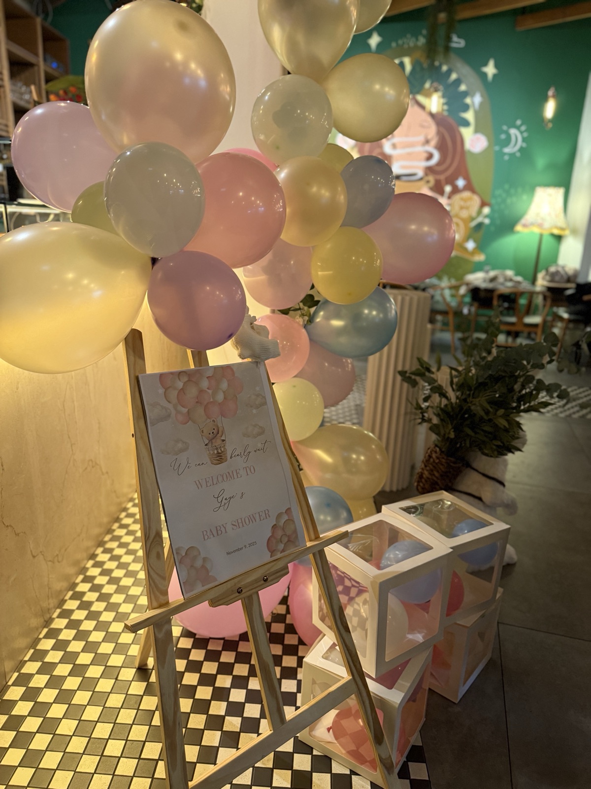 Baby shower welcome sign framed with pastel balloons